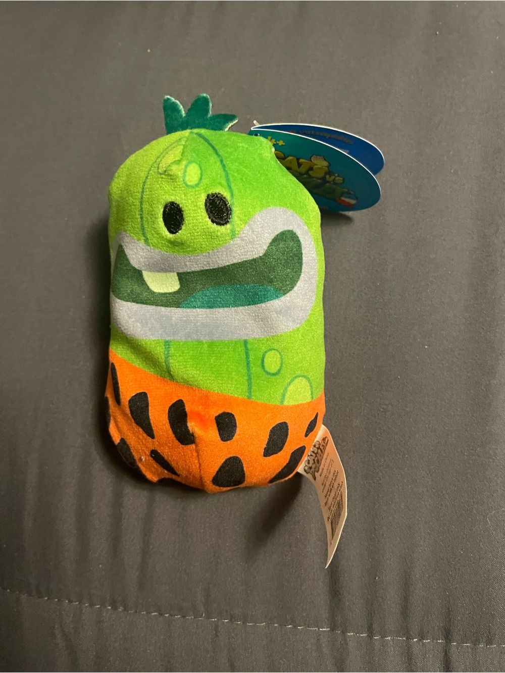 Green Cartoon Plush Toy with Orange Base
